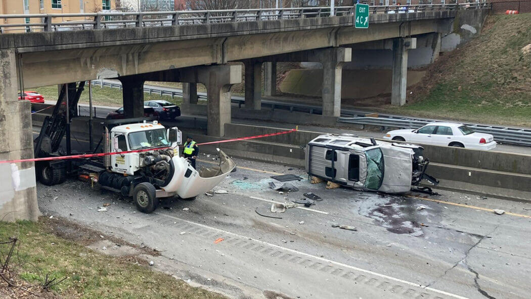 Image of a car crash under a bridge.
