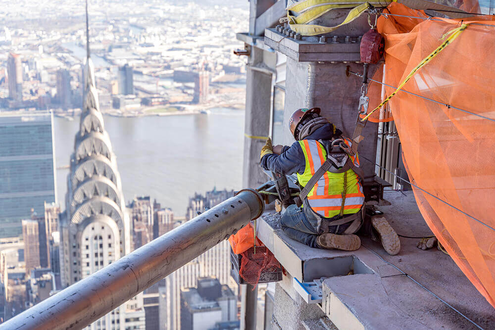 construction worker atop building in New York